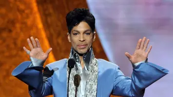 Crowd gathers at an outdoor event honoring musician Prince