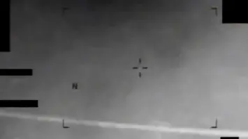 Infrared image showing an eight-pointed star-like object in the sky.