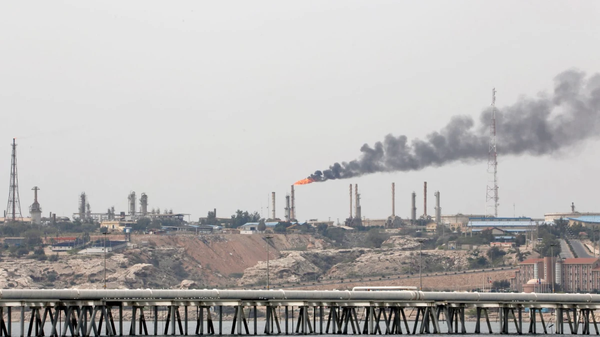 Oil pipelines running through a desert landscape.