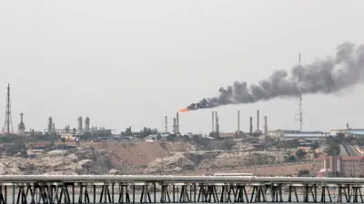Oil pipelines running through a desert landscape.