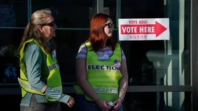 Voting booth with American flag, representing U.S. elections