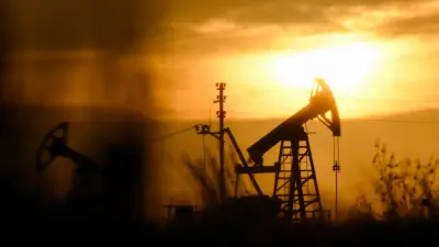 Oil barrels with a backdrop of a financial graph indicating rising prices.