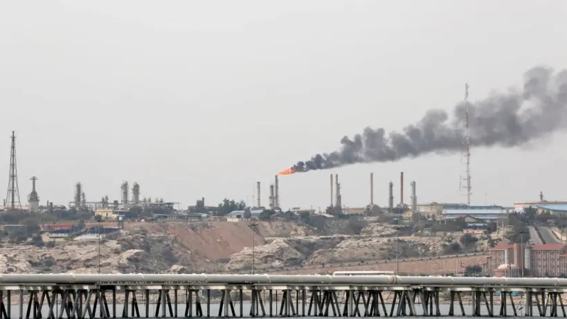 Oil pipelines running through a desert landscape.